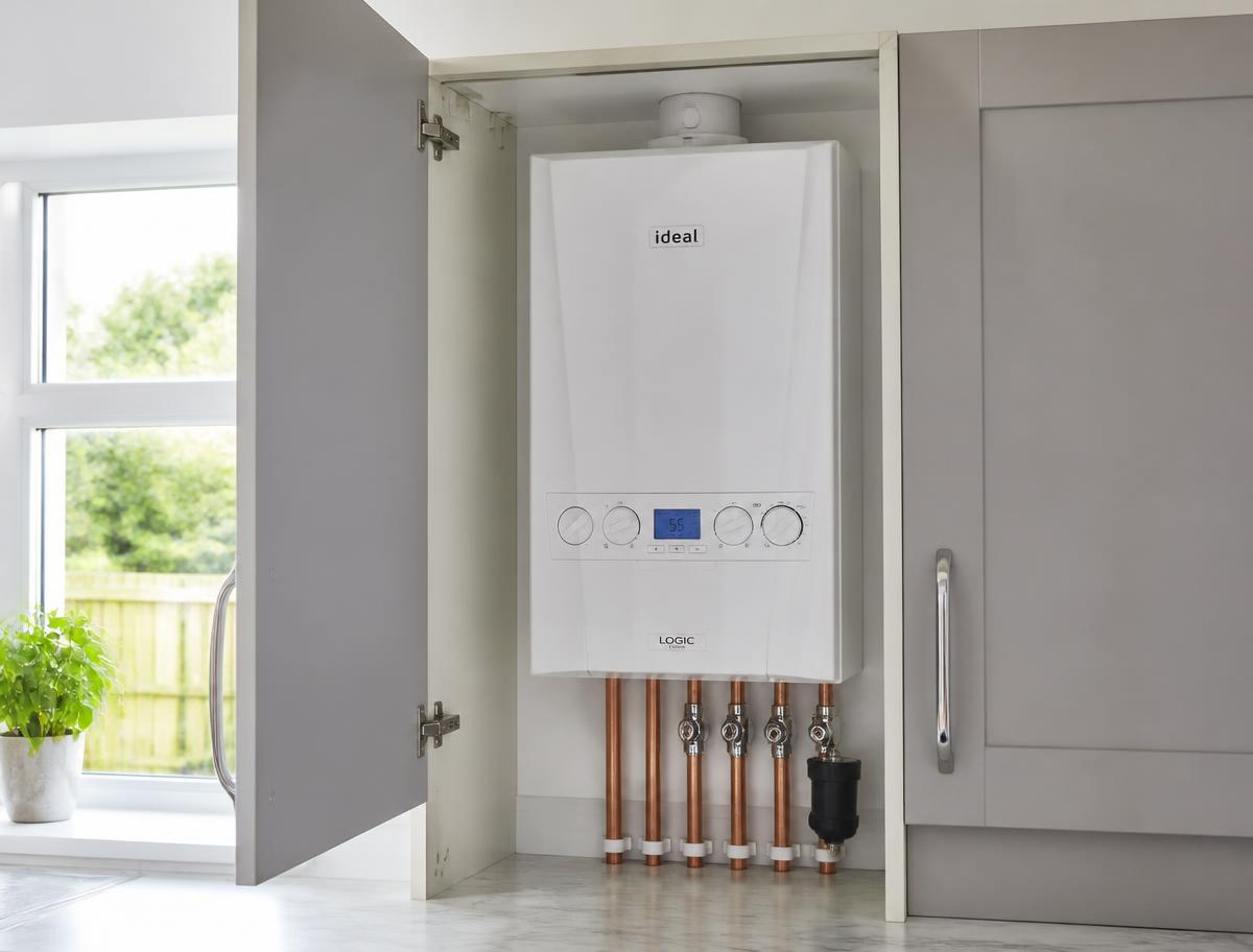 New combi boiler installed neatly in a kitchen cupboard